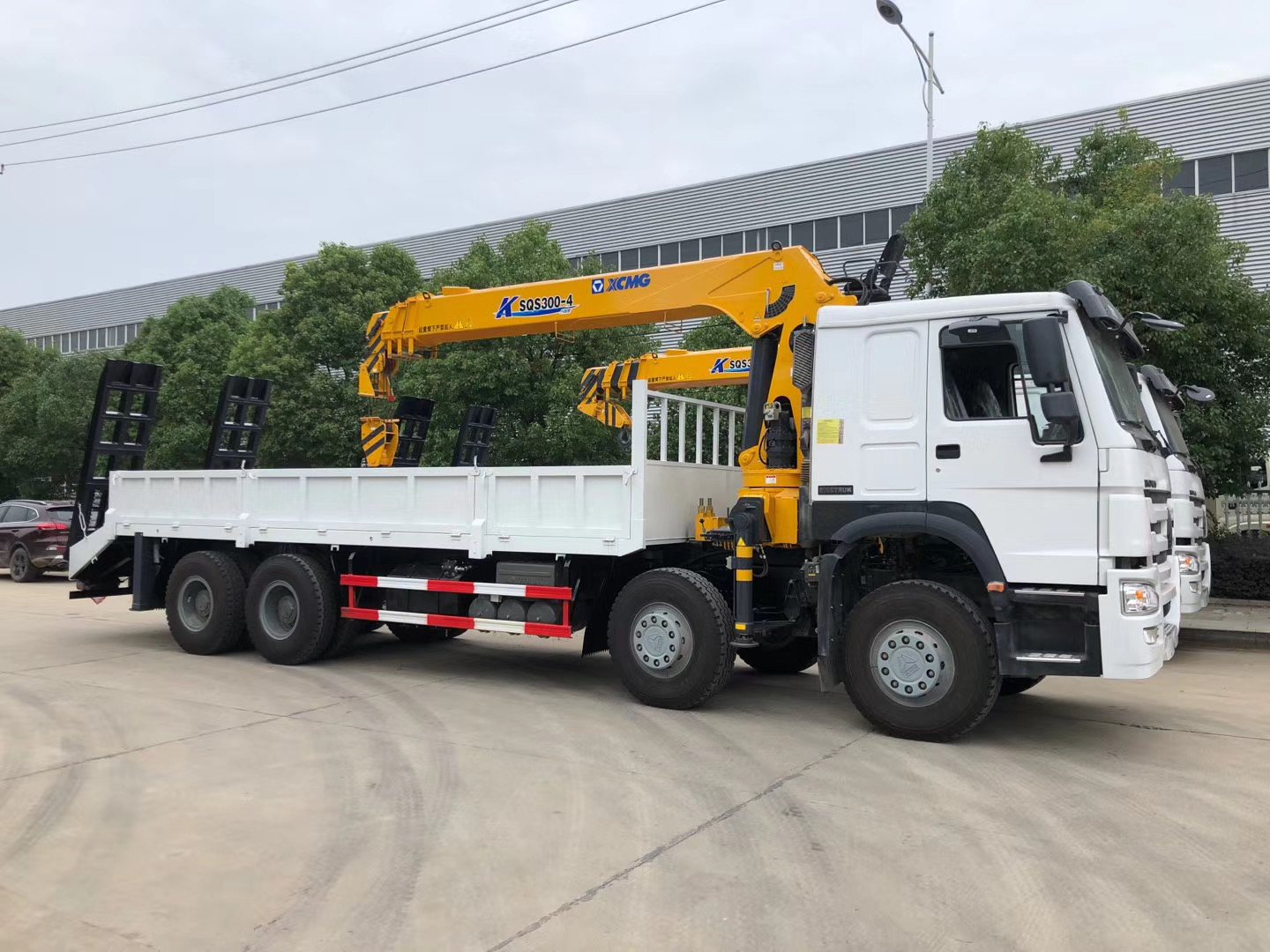 CLW Group HOWO crane truck carrying heavy equipment