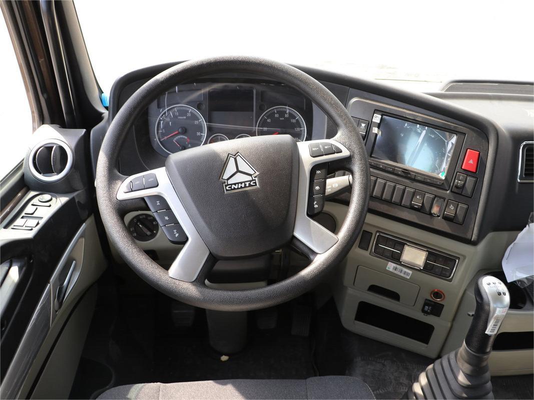 Driver operating HOWO garbage truck