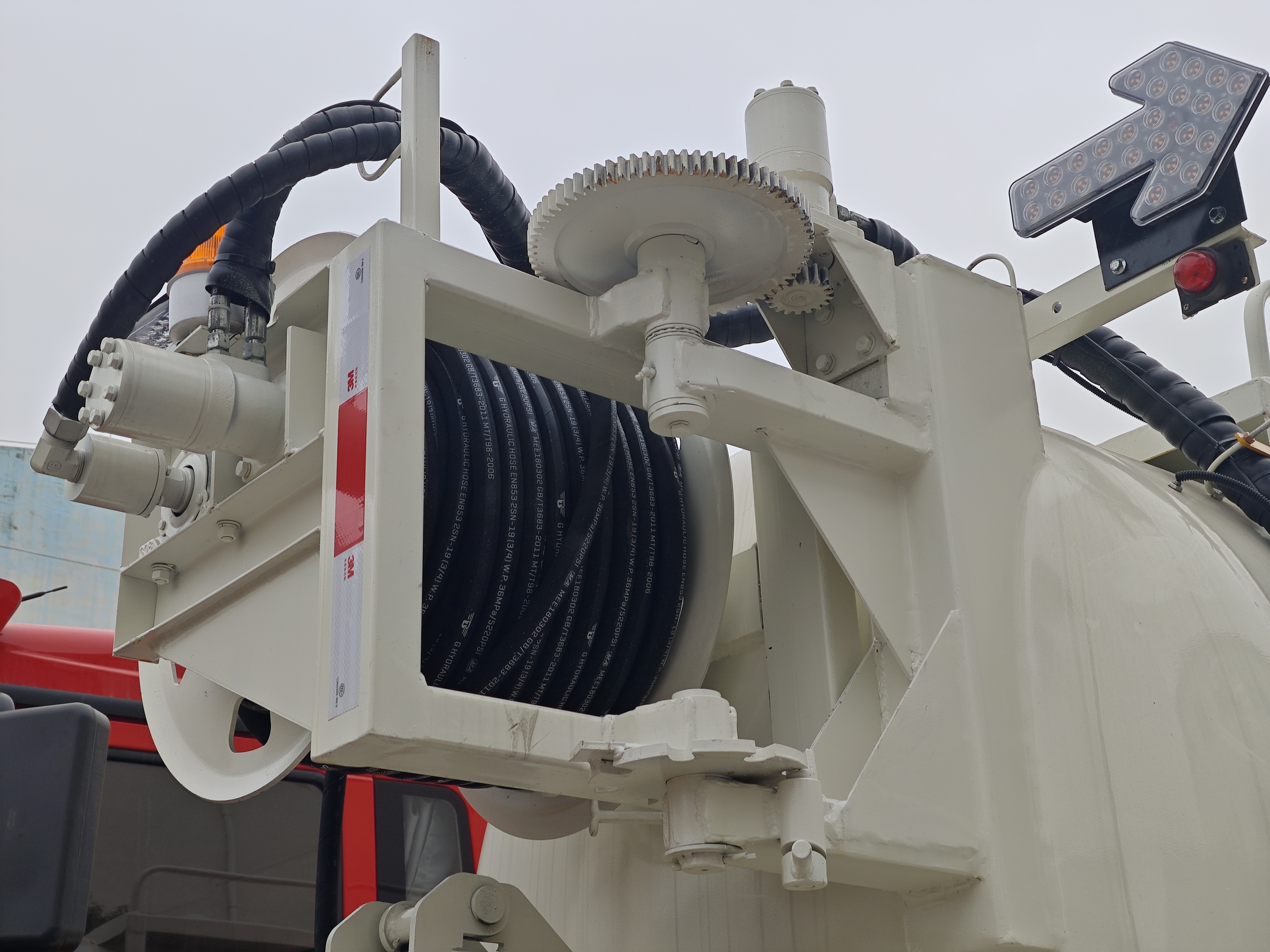 Side view of FAW vacuum sewage truck with suction hose