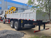 Shacman 6x6 Cargo Truck with Knuckle Boom Crane lifting heavy materials on a construction site